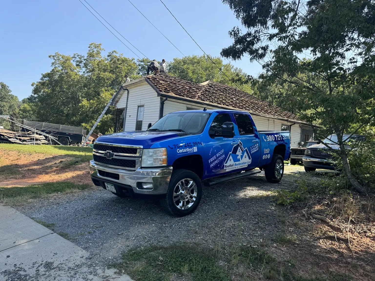 Roofiolli Restoration crew removing an existing roof in China Grove, North Carolina