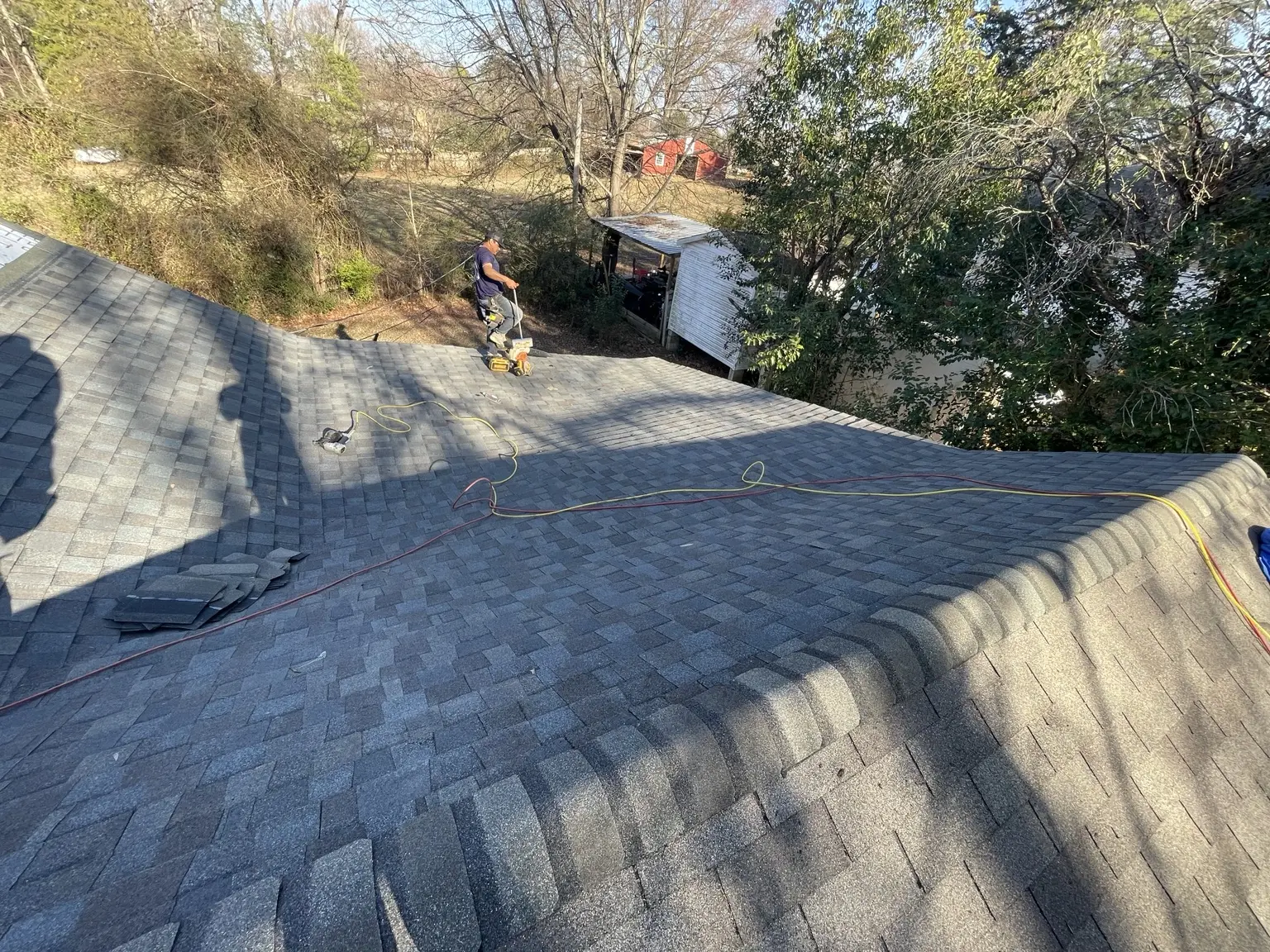 Roof-level view of Roofiolli Restoration shingle installation work in Concord, North Carolina